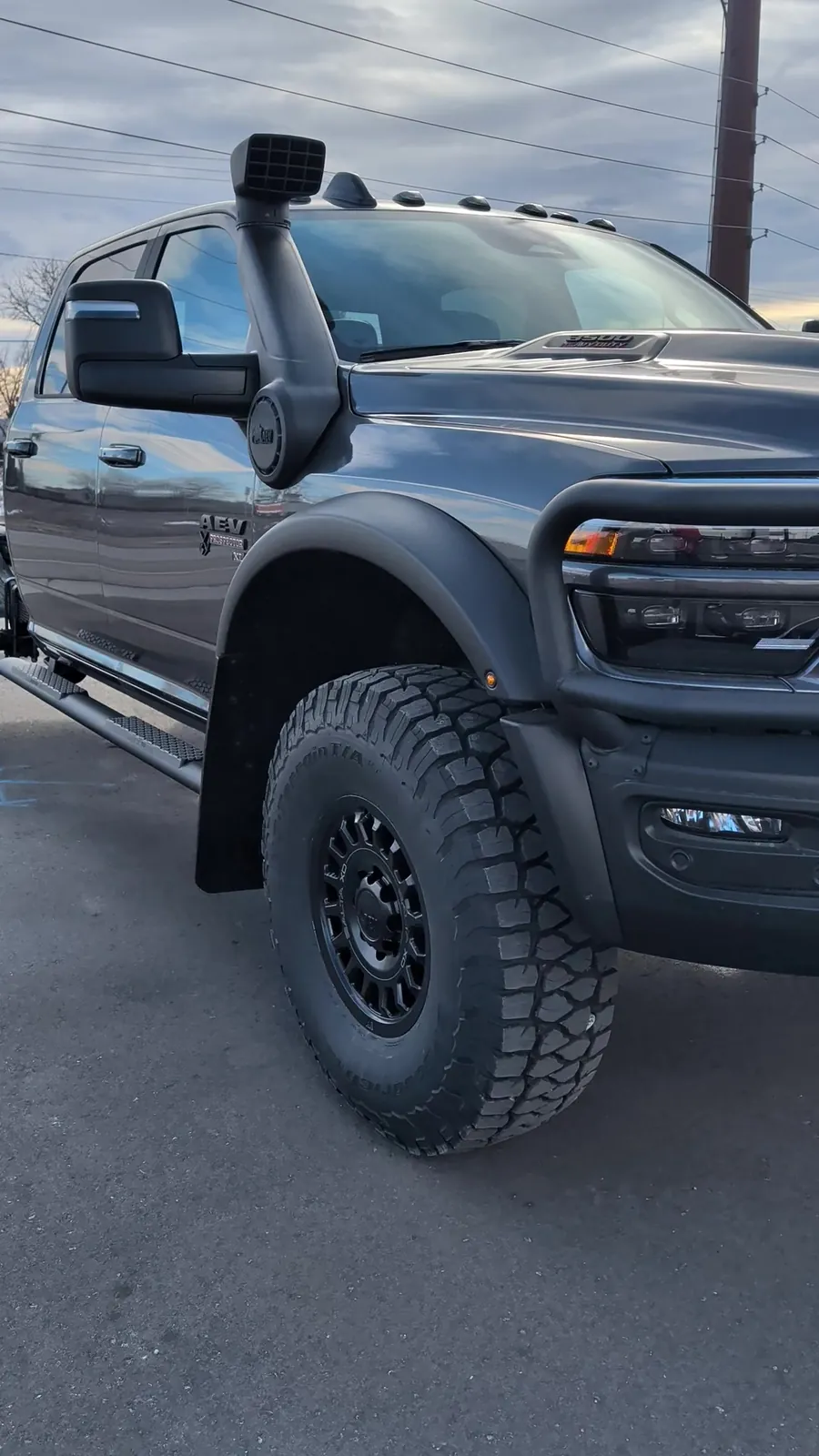 Front three-quarter with the AEV snorkel and HighMark fender flares