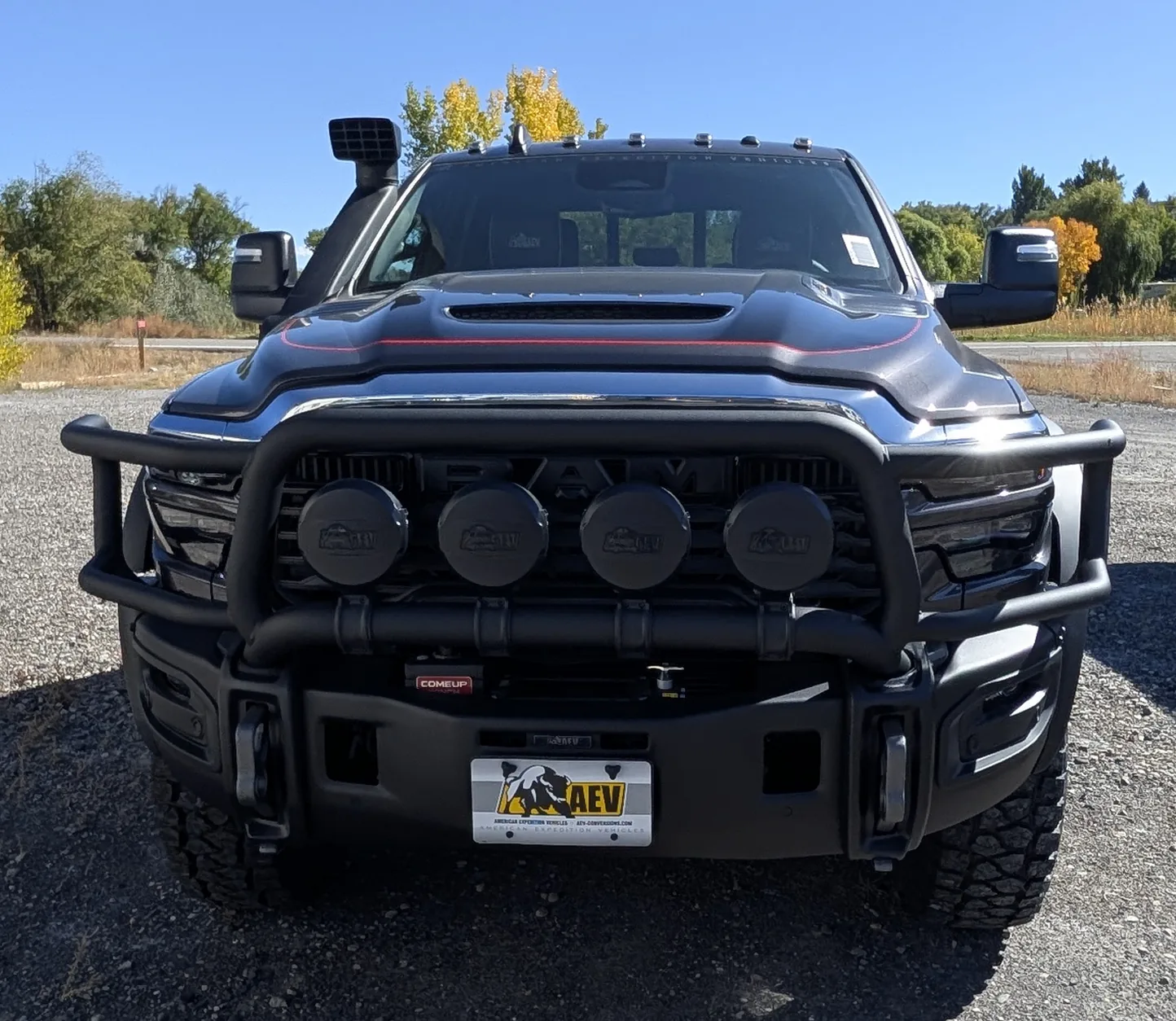 Head-on view of the AEV front bumper, brush guard, four AEV lights and winch